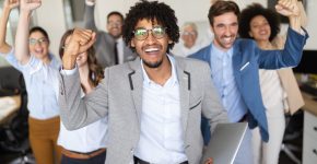 Happy business people celebrating success at modern company