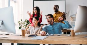 happy multiracial business team working on project together in office
